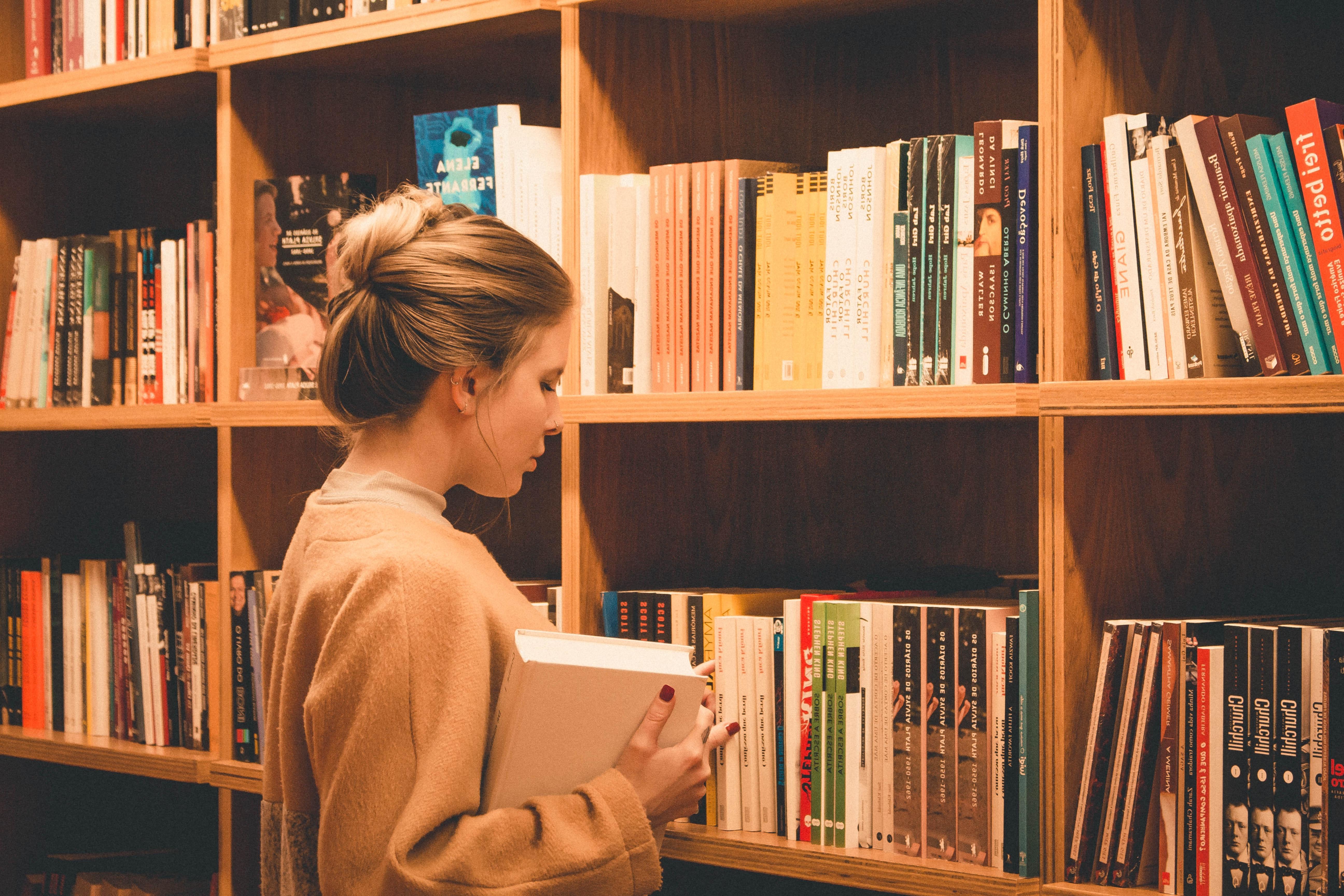 female student looking at books